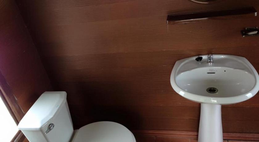a white toilet sitting next to a sink in a bathroom, Sarocha Resort Rayong in Rayong
