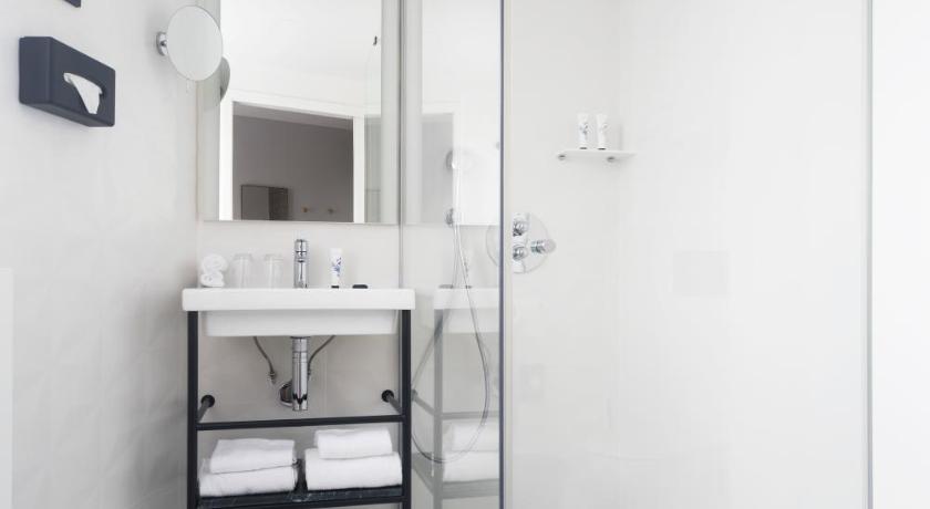 a bathroom with a sink, toilet, and shower, Doisy Etoile Hotel in Paris