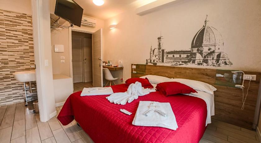 a bedroom with a large bed and a large window, B & B Santa Maria Novella in Florence