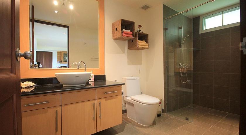 a bathroom with a toilet a sink and a mirror, Sea Ridge Penthouse in Hua Hin / Cha-am