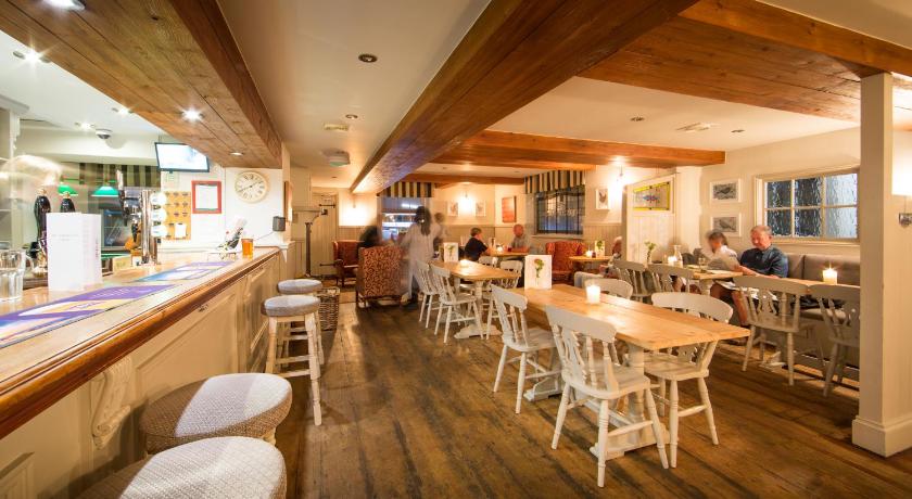 a kitchen with wooden floors and wooden tables, Darlington Arms in Bristol