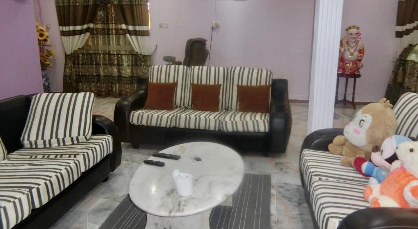 a living room filled with furniture and a couch, Shuang Yang Sekinchan Homestay 7 in Sabak Bernam