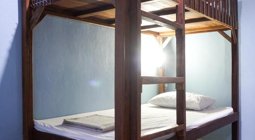 a bunk bed in a room with a wall behind it, ZLEEP63 Hostel in Bangkok