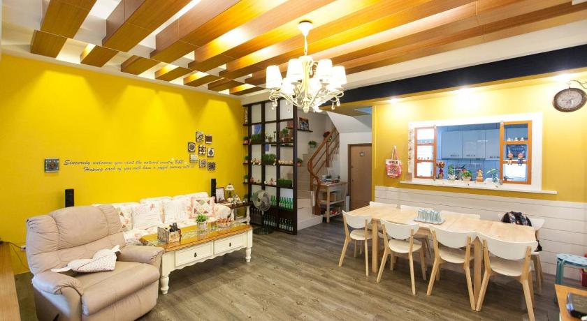 a living room filled with furniture and a large window, 12 Kids House in Yilan