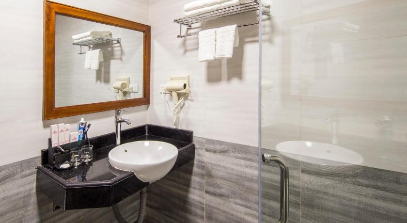 a bathroom with a sink, toilet and bathtub, Sapa Lodge Hotel in Sapa
