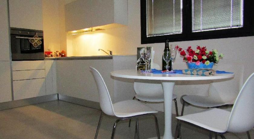 a kitchen with a table and chairs in it, Le Suite di Luna Rossella in Bologna