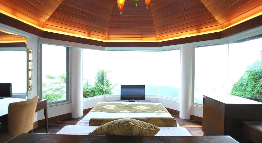 a room with a bed and a window, Villa Ibarra Tagaytay in Tagaytay