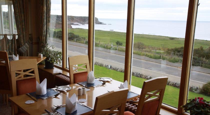 a dining room table with chairs and a window, Cullen Bay Hotel in Cullen