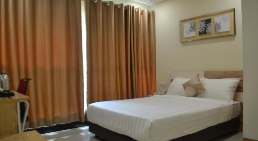 a bedroom with a large bed and a large window, My Inn Hotel in Kuching