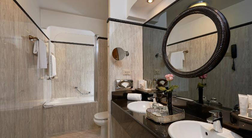 a bathroom with a sink, mirror, and bathtub, Melia Paris Vendôme in Paris