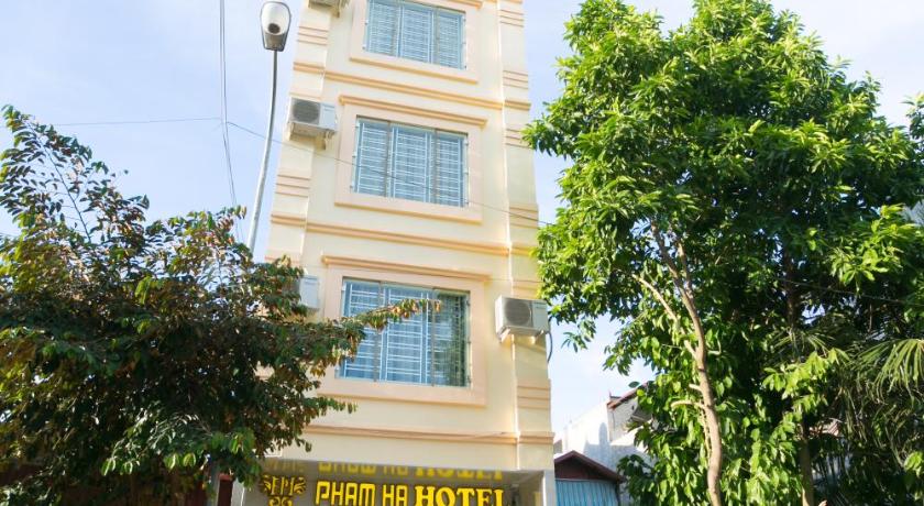 a large building with a clock on the front of it, Pham Ha Hotel in Haiphong