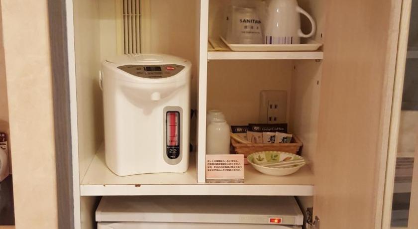 a white refrigerator freezer sitting inside of a kitchen, Hotel Elegance (Love Hotel) in Karatsu