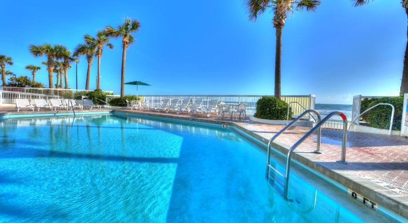 a pool with a blue chair and a blue bench, Bahama House - Daytona Beach Shores in Daytona Beach (FL)
