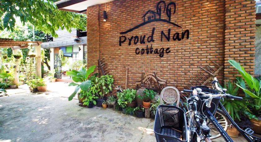 a bicycle parked in front of a brick building, Proud nan cottage in Nan