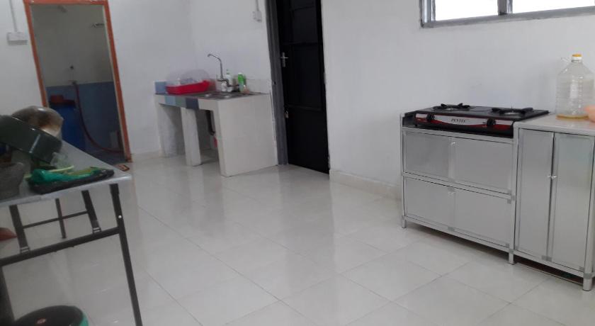 a kitchen with a stove and a sink, Nur Aisyah Homestay in Taiping