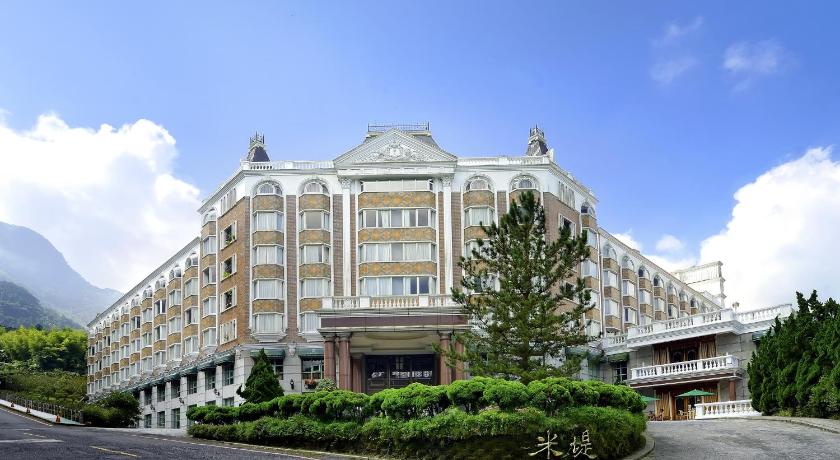 a large building with a clock on the front of it, Le Midi Hotel in Nantou