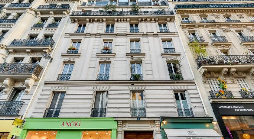 a large building with a large window on the side of it, Sweet Inn - Tardieu in Paris