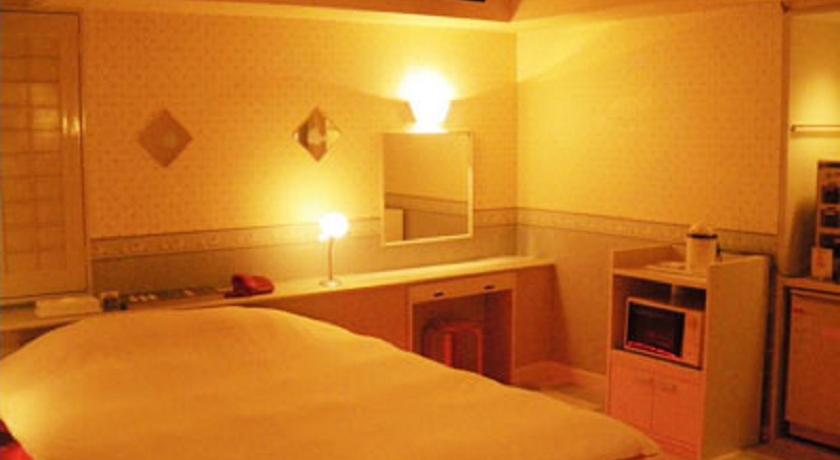 a room with a bed, a lamp, and a window, Hotel Green Hill in Fukaya