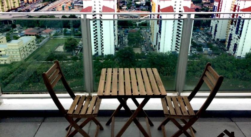 two wooden chairs sitting in front of a building, S Suites @ The Scott Garden in Kuala Lumpur