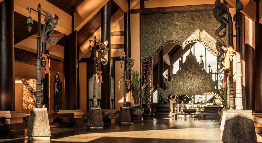 a living room filled with furniture and a fire place, Anantara Golden Triangle Elephant Camp & Resort (SHA Extra Plus) in Chiang Saen (Chiang Rai)
