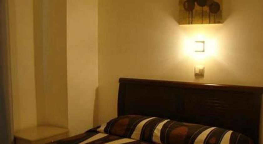 a hotel room with a bed and a lamp, Hotel Astron in Karditsa