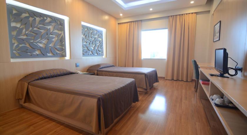 a hotel room with a bed and a television, Charoen Hotel (SHA Extra Plus) in Udon Thani