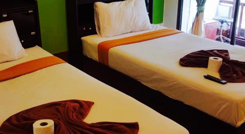 a hotel room with two beds and two lamps, Lucky Guest House in Ko Phi Phi