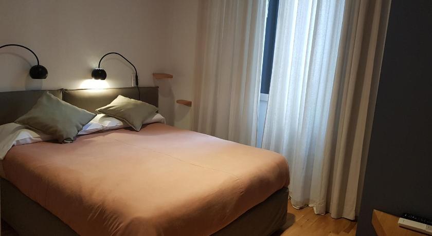 a bedroom with a bed and a lamp on the wall, B&B Santa Maria del Fiore in Florence