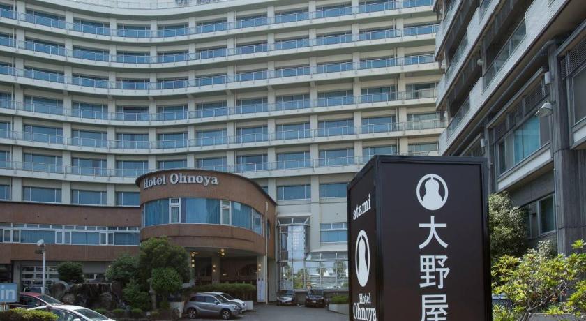 a large building with a clock on the front of it, Hotel Oonoya in Atami