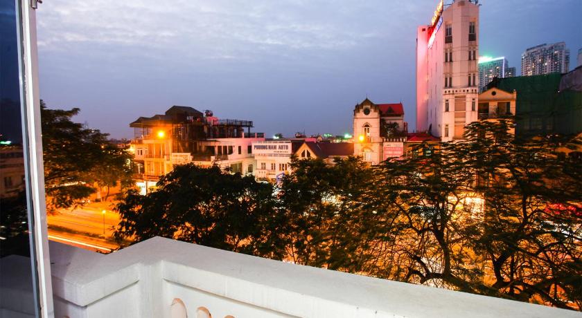 a large building with a balcony overlooking a city, Phuong Trang Hotel in Hanoi