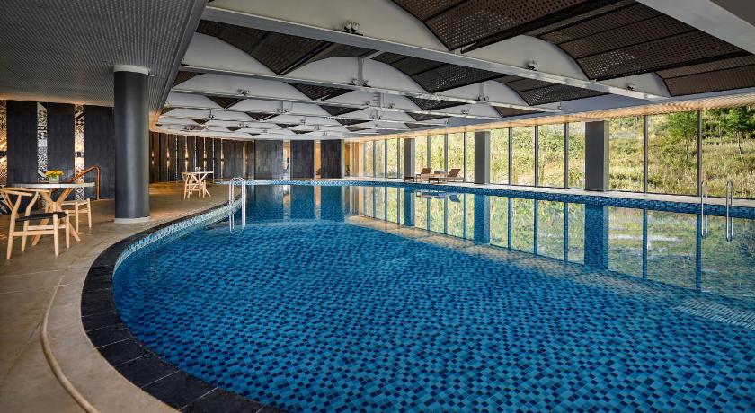 a swimming pool with a pool table and chairs, Pao's Sapa Leisure Hotel in Sapa
