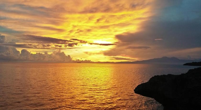 a sunset over a body of water, Cliff Garden in Siquijor Island