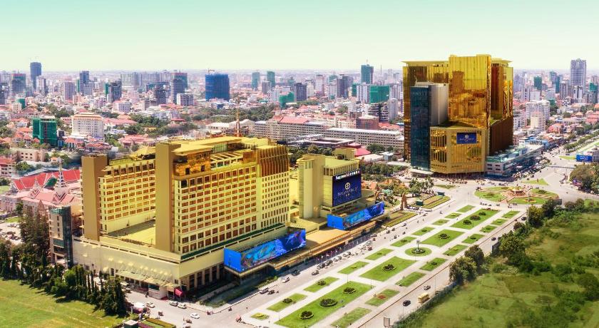 a train on a track in a city, NagaWorld Hotel & Entertainment Complex in Phnom Penh
