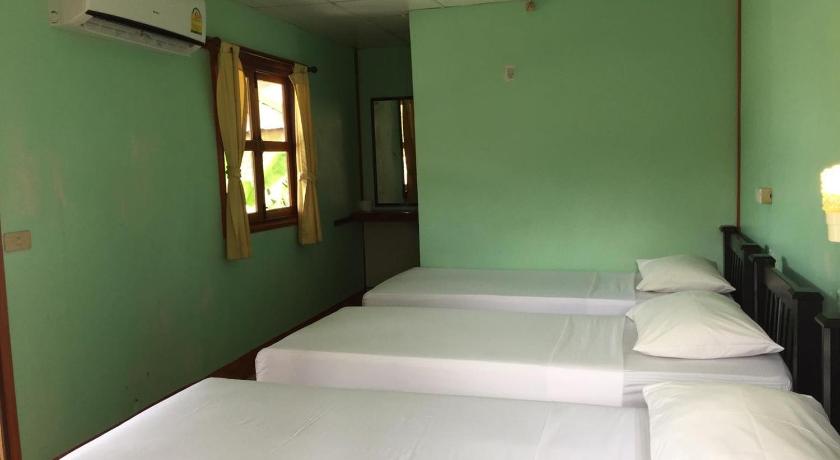 a room with two beds and a window, Golden Guesthouse in Ko Phi Phi
