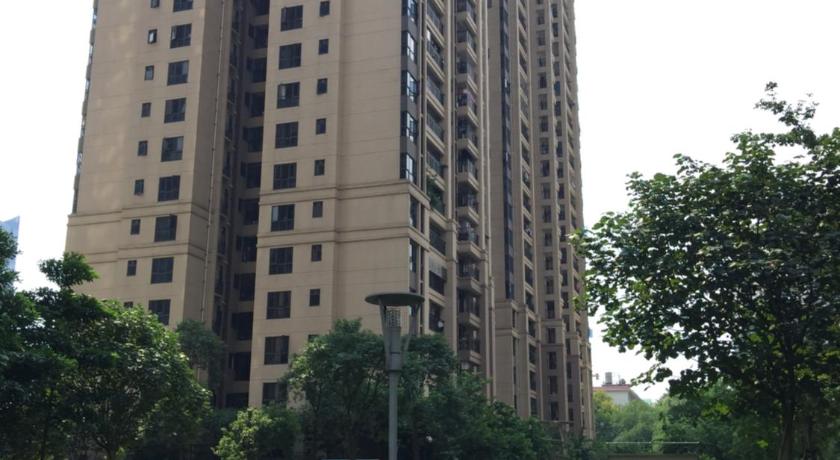 a large building in the middle of a grassy area, Lan House Youth Apartment in Guangzhou