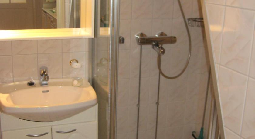 a bathroom with a shower, sink, and toilet, Polar Star Moonlight Apartments in Levi