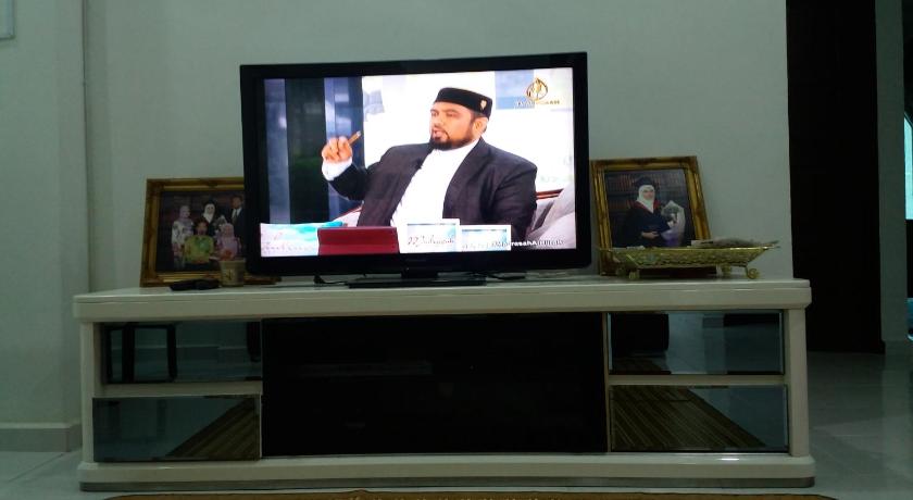 a tv sitting on top of a stand in a living room, Villa Fairuz Hana in Kangar