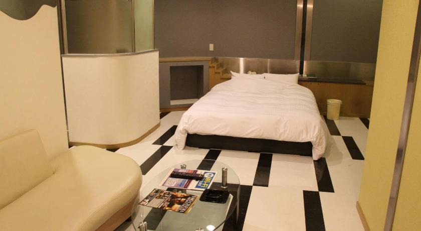 a hotel room with a bed, desk, and mirror, Color Hotel (Love Hotel) in Kumamoto