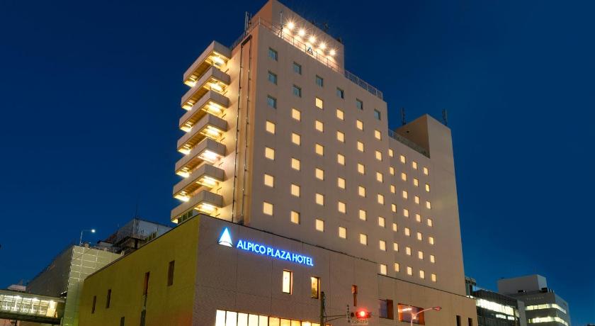 a large building with a large clock on it's side, Alpico Plaza Hotel in Matsumoto