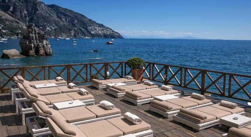 a row of boats sitting on top of a pier, Hotel Le Agavi in Positano