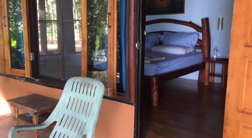 a room with a bed, chair, and a window, Dugong Koh Sukorn in Trang