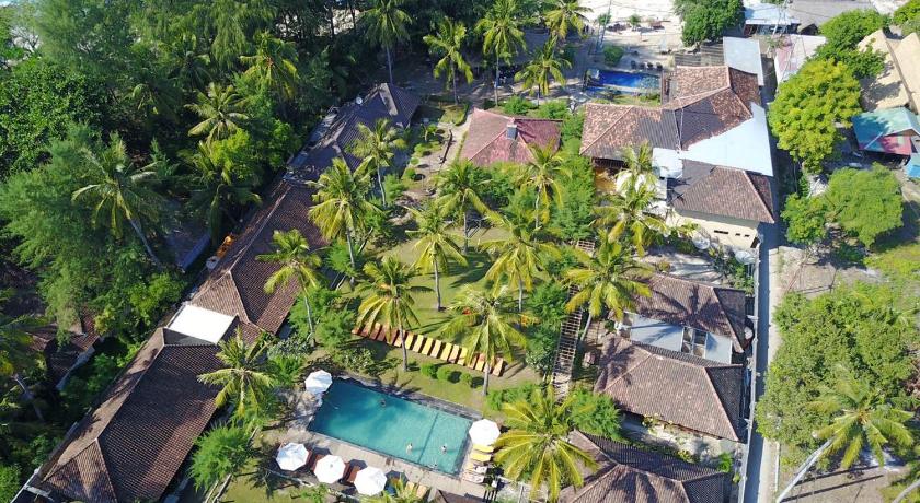 a beach with palm trees and palm trees, Royal Regantris Villa Karang in Lombok