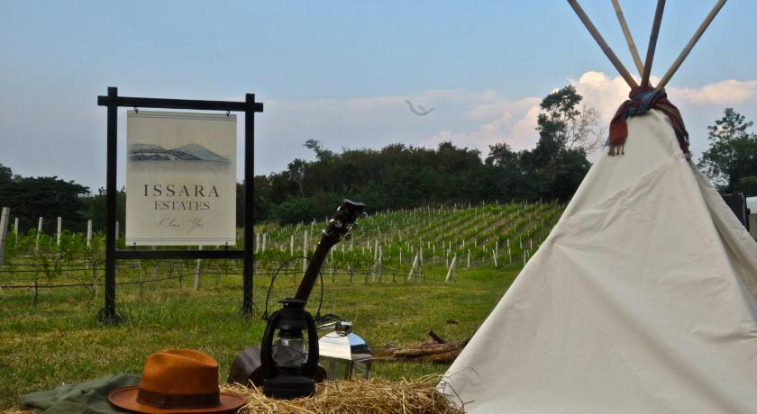 a tent is set up in the middle of a field, Issara Boutique Winery Hotel in Khao Yai