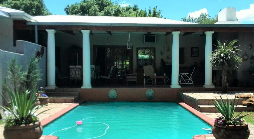 a pool with a pool table and chairs in it, DeKat Self Catering in Burgersdorp