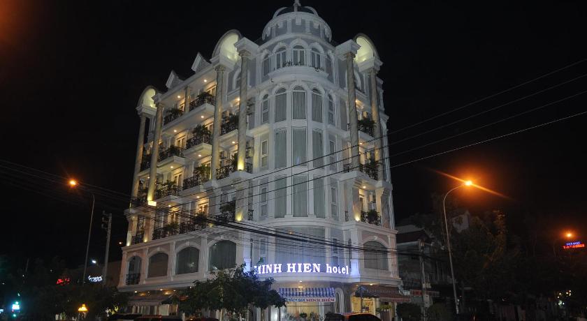 a large building with a clock on the side of it, Minh Hien Hotel in Phan Thiet