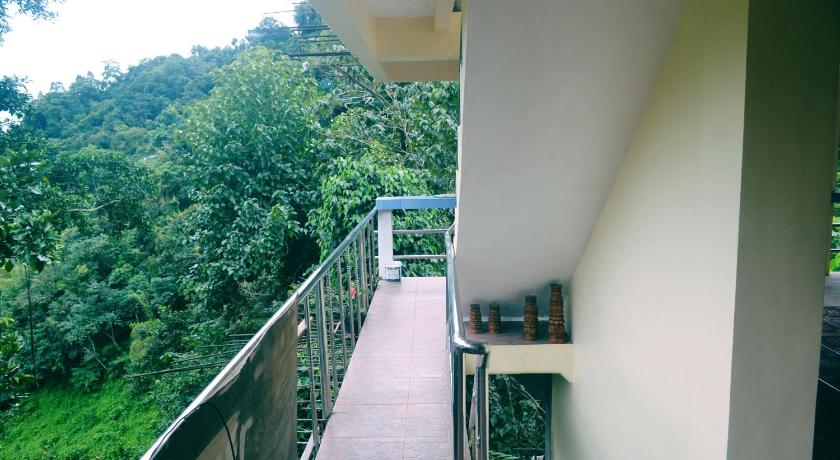 a walkway leading to a balcony overlooking a river, Highland Inn and Restaurant in Banaue