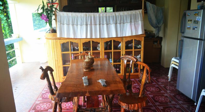 a dining room table and chairs in a room, Highland Inn and Restaurant in Banaue