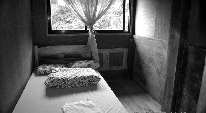 a room with a bed and a window, Highland Inn and Restaurant in Banaue