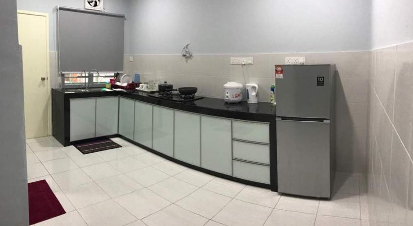 a kitchen with a refrigerator and a counter top, ARA Muslim House @ Mutiara Heights Johor Bahru in Johor Bahru