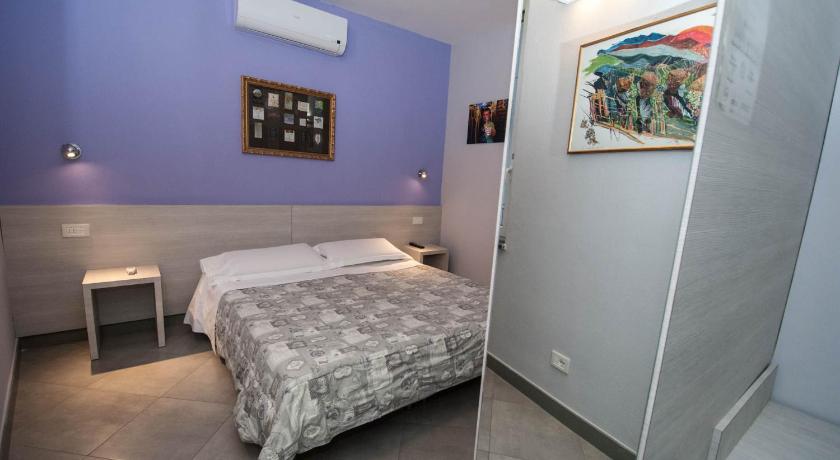 a bedroom with a bed, desk and a painting on the wall, Le Coste by Arbaspaa in Riomaggiore